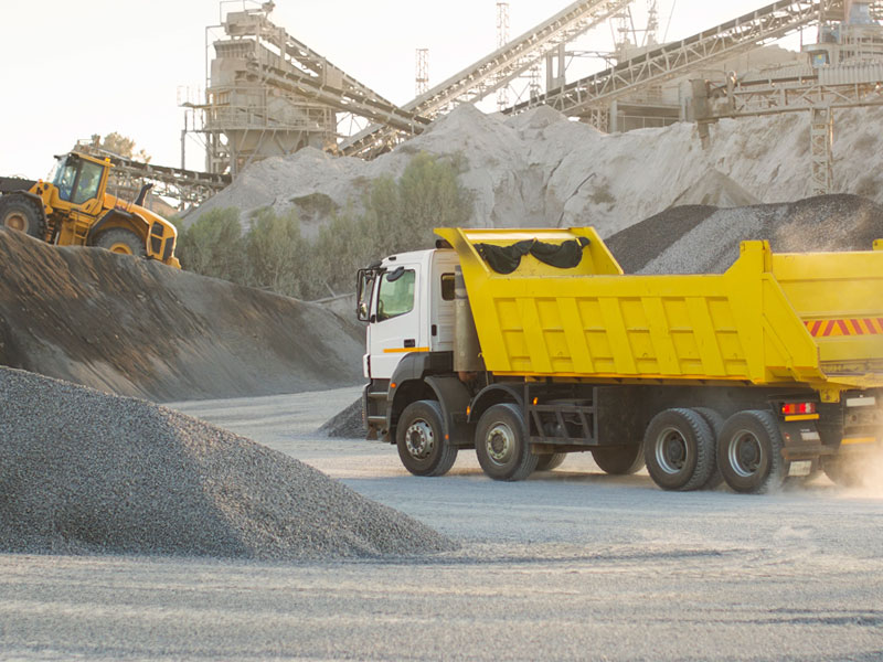 Dump truck at a quarry to illustrate the trucking industry