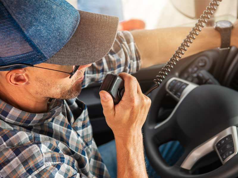 Truck driver communicating from his radio to illustrate effective communication in construction hauling