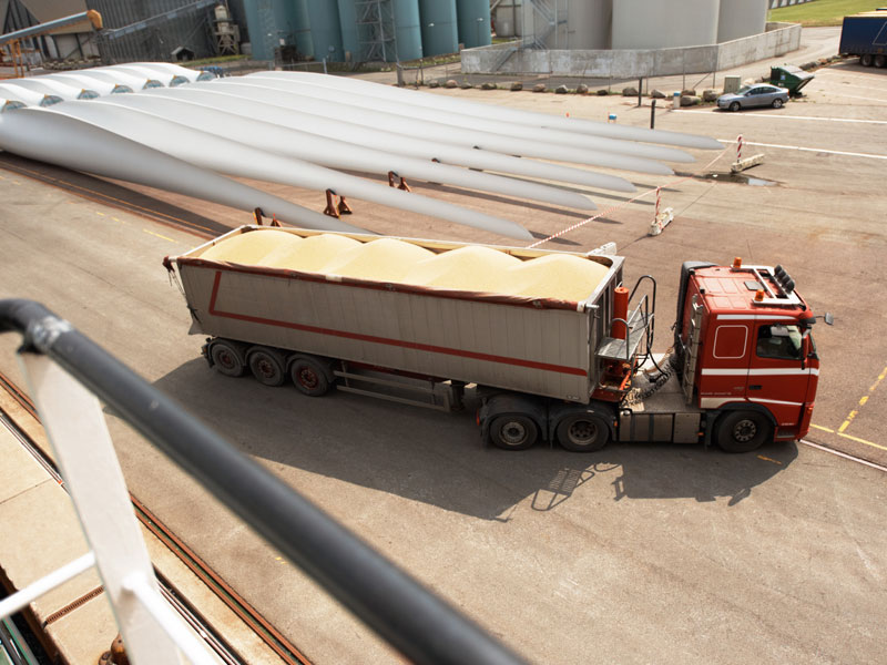 Truck delivery materials to a wind farm construction site to illustrate dump truck hauling