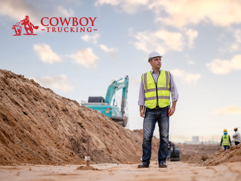 Engineer in hi-vis on a construction site to illustrate keeping rules and regulations when hauling construction materials